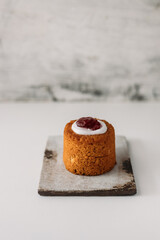 Runebergin torttu, famous Finnish Runeberg cake tart pastry made of almonds, rum, raspberry jam, pink background. Baked on February 5, Runeberg's birthday