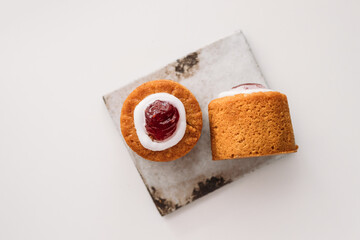 Runebergin torttu, famous Finnish Runeberg cake tart pastry made of almonds, rum, raspberry jam, pink background. Baked on February 5, Runeberg's birthday