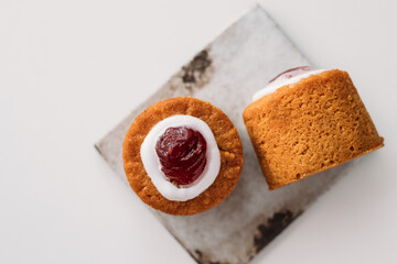 Runebergin torttu, famous Finnish Runeberg cake tart pastry made of almonds, rum, raspberry jam, pink background. Baked on February 5, Runeberg's birthday