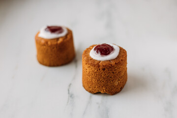 Runebergin torttu, famous Finnish Runeberg cake tart pastry made of almonds, rum, raspberry jam, pink background. Baked on February 5, Runeberg's birthday