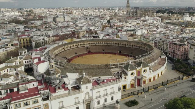 Plaza de Toros or bullring and cityscape, Seville in Spain. Aerial circling