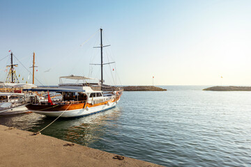 Obraz premium The view across the harbour in Side, Turkey at sunset. Mediterranean resort with copy space.