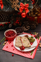 Fototapeta na wymiar Portion of Traditional French terrine covered with bacon and decorated Christmas tree