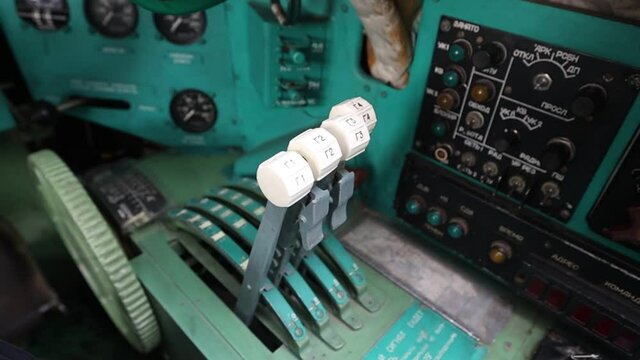 Thrust control levers for four engines in the Tu-95 Soviet strategic turboprop bomber. The cockpit is inside. Natural light. Full HD.120 fps.