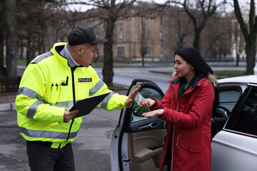 Police officer rejecting bribe near car outdoors