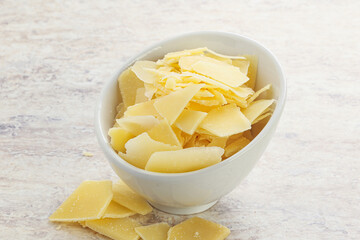 Sliced parmesan cheese heap in the bowl