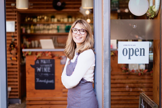 Smiling Middle Aged Woman Standing In The Cafe While Reopening After Pandemia