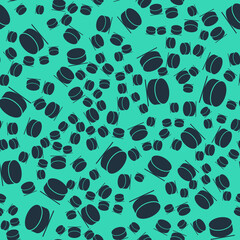 Black Hockey puck icon isolated seamless pattern on green background. Vector