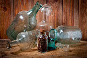 Old vintage glass containers and bottles of different shades and sizes.