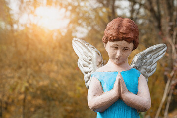 Angel child in prayer. (concept: loss, death)