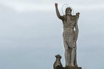 Ancient statue of Jesus Christ the Good Shepherd with a lost sheep at his feet (concept of faith)
