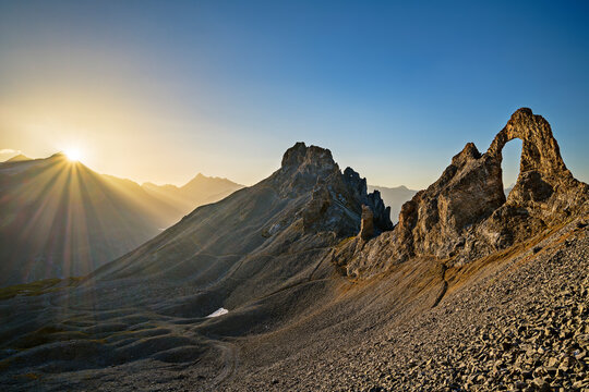 Laiguille Percee arch at sunrise at Laiguille Percee Rock, Vanoise National Park, France