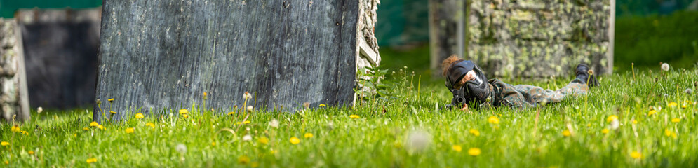 young woman in action while playing paintball