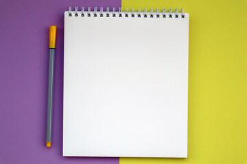 Bright stationery, notebook on pink yellow background. Back to school, workspace concept. Top view, flat lay