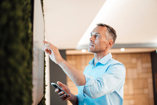 Businessman pointing at touch screen computer monitor in coworking office
