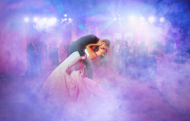 first dance - Elegant wedding by night. Groom kisses the bride in a waltz - obrazy, fototapety, plakaty