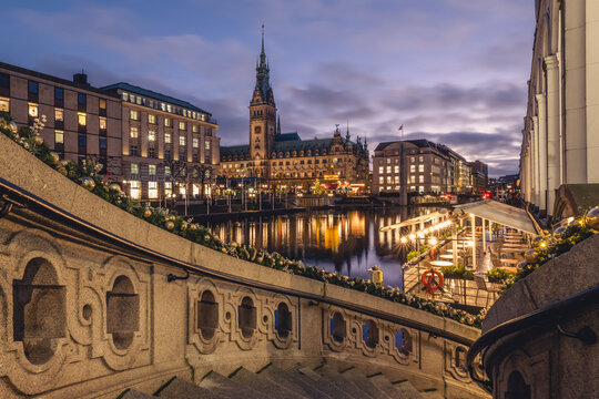 Germany, Hamburg, Exterior staircase at dusk with Kleine Alster and city hall in background