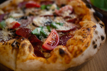 delicious fresh pizza with salami, basil and tomatoes