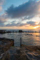 Fototapeta na wymiar Cloudy sunrise over Mahon Pool, Sydney, Australia.