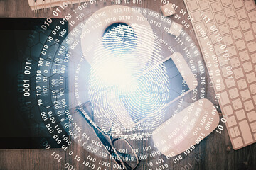 Double exposure of finger print over table with phone. Top view. Concept of mobile security.