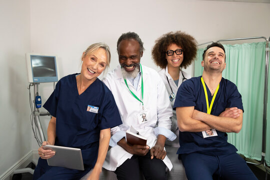 Cheerful doctors and nurses together in medical room