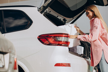 Woman putting shopping bags into her car