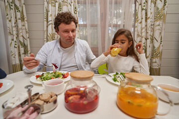Delighted male person looking at tea pots