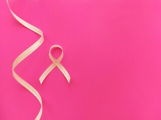 light ribbon on a pink background as a symbol of breast cancer in women, AIDS