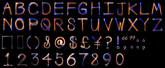 Long exposure, light drawn, uppercase alphabet.