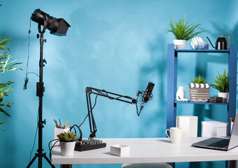 Professional video light stand in empty vlog broadcasting studio with microphone used for recording...