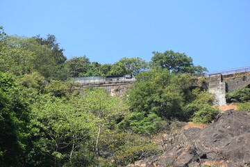 Fototapeta na wymiar waterfall with rail bridge in goa