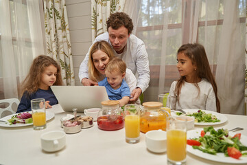 Happy family being at home together and enjoying dinner