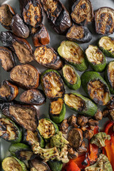Grilled zucchini, mushrooms and Brussels sprouts. Laid out on a stainless steel baking sheet, top view.