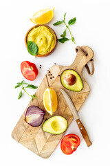 Homemade guacamole avocado dip with tomatoes and lime