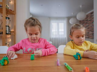 Little girls modeling something from clay.