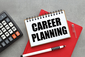 Career Planning text in open notepad on red notepad on gray background