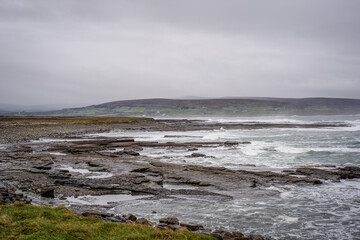 image of Atlantic ocean sea waves splashing with white foam against rocks, beach, rocky cliff, Ballycastle,mayo,ireland. Sea patterns, background wallpaper. Wild Atlantic Way Landscape
