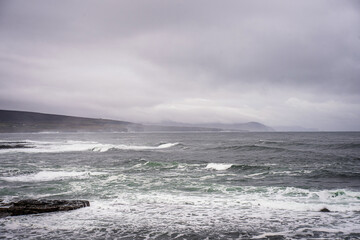 image of Atlantic ocean sea waves splashing with white foam against rocks, beach, rocky cliff, Ballycastle,mayo,ireland. Sea patterns, background wallpaper. Wild Atlantic Way Landscape