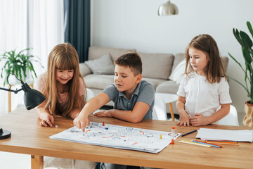 Fototapeta premium Step by step game. Kids having fun in the domestic room at daytime together