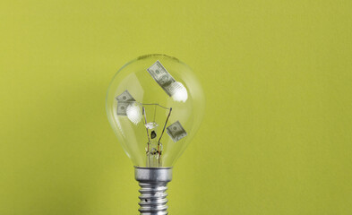 Light bulb with money inside. Dealing with the energy crisis a light bulb with money inside. Electricity prices going up.