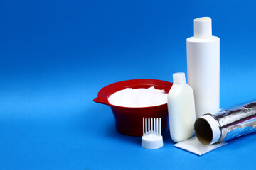 Hair dye and coloring tools for a barber shop on a blue background