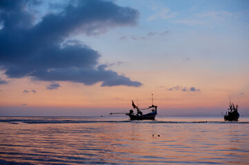 Beautiful tropical sunset. Seascape with purple sky and longtail boats. Samui Island, Thailnd.