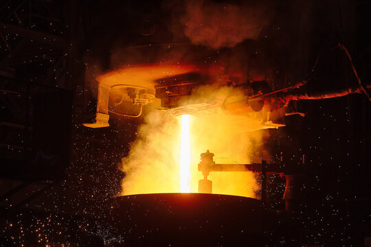 Ingot casting, metal sparks. Ladle-furnace. Iron smelting, Steel production. Electric steel furnace. Metallurgy. Industry steel production. 
