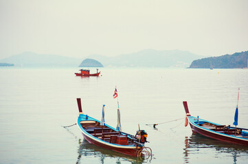 Travel by Thailand. Landscape with traditional longtail fishing boat on the sea beach.