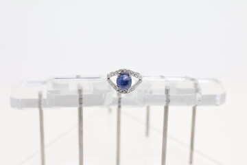Blue Sapphire rings with Blue ribbon on white background. Jewelry set of gemstone and diamonds for shop