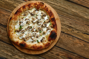 Appetizing pizza with mushrooms on a wooden tray