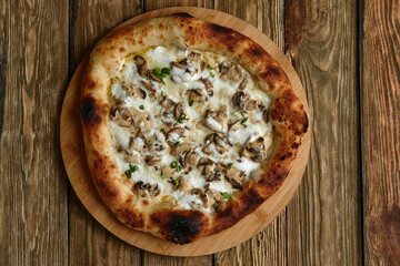 Appetizing pizza with mushrooms on a wooden tray