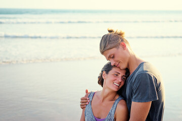 Love and romance. Honeymoon on the sea shore. Beautiful loving couple embracing on the beach.