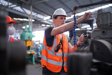 Male engineer metalworker industrial experienced operator technician worker in safety hard helmet...