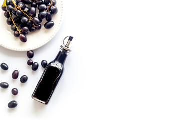 Balsamic vinegar with bunch of fresh grapes